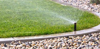 Image of sprinkler watering a lawn